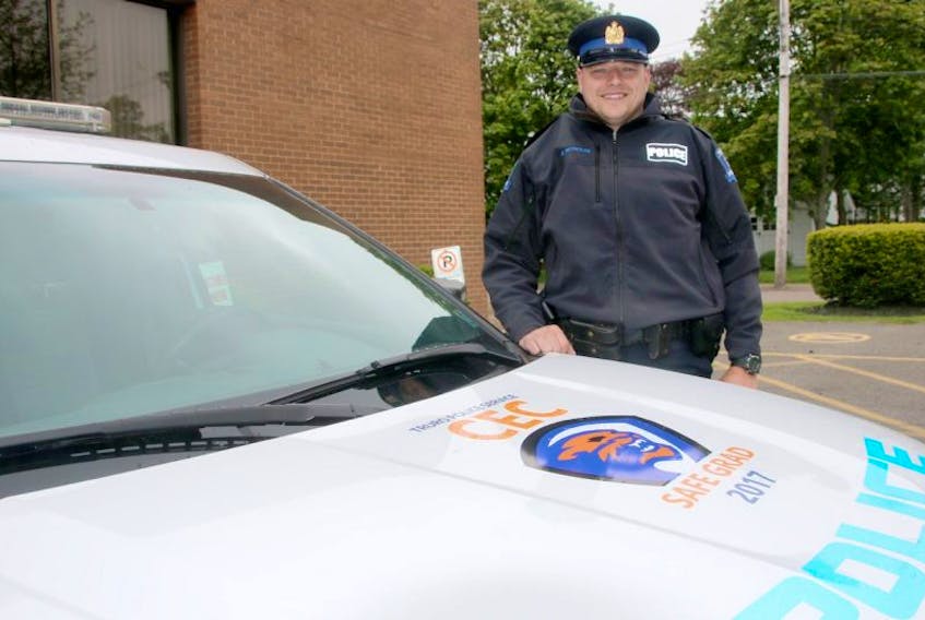 Truro Police Const. Edwin Reynolds is pleased to have the Safe Grad logo on one of the police cars. This year’s logo was designed by student Noah Desmond and will remain on the car until Safe Grad, which is being held June 27, is over.