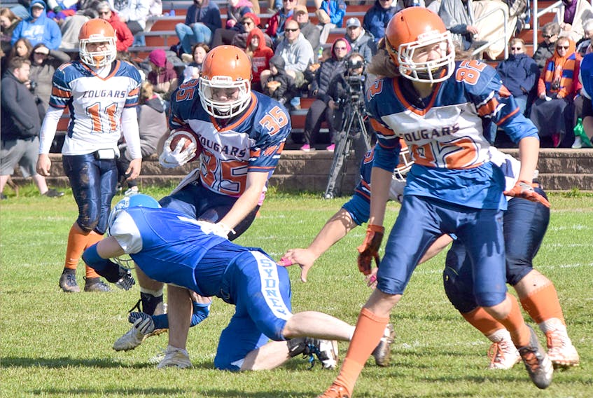 Cobequid Cougars running back Torro Gabrielli looks to avoid a tackle during first-half action of the Cougars game against the Sydney Academy Wildcats last Sunday at James MacPherson Stadium in Truro.