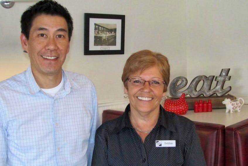 Dave Tam, left, the owner of Fletcher’s Restaurant and longtime employee Debbie Curry.