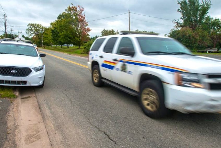 RCMP leave the Tatamagouche satellite office after an incident involving an armed individual in the area on Monday.