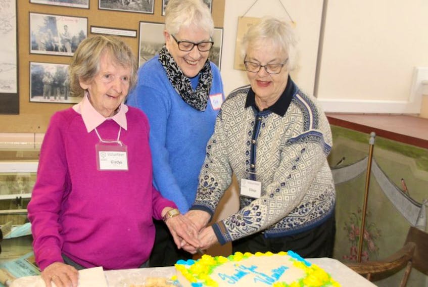 Cutting the cake at the Colchester Historeum volunteer social were, from left, Gladys Otterson, Pam Tonary and Elinor Maher. All three woman are volunteers at the museum.