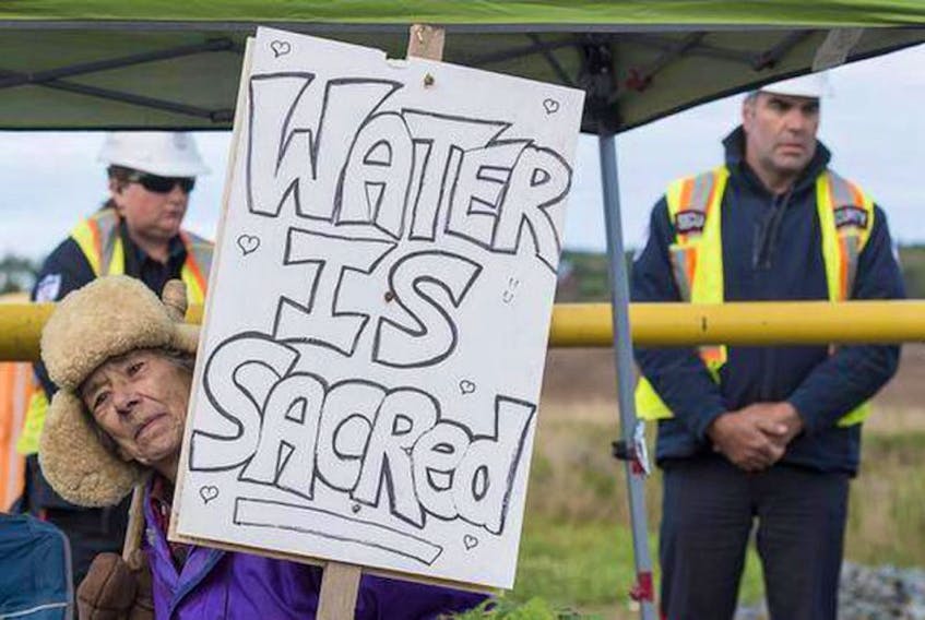 Annabelle Thiebaux protests at the entrance of a work site in 2016 near the Shubenacadie River in Fort Ellis, where AltaGas has proposed to build undergound gas storage caverns.