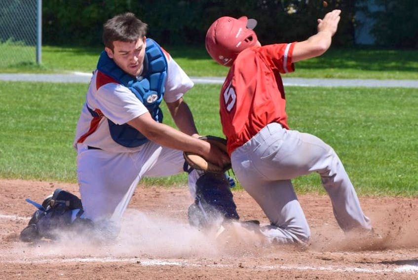 Truro Bearcats catcher Morgan Jobes applies the tag on a play at the plate during Nova Scotia Intermediate Baseball League action Sunday in Truro. The Bearcats split a doubleheader with the Windsor Knights.
