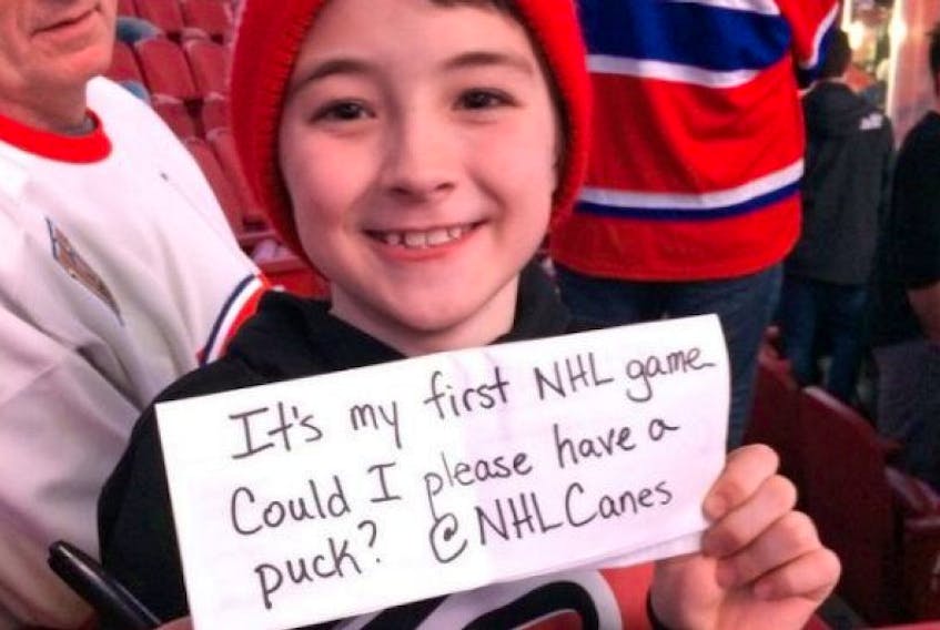 Caiden Chambers watches warmup at his first NHL game between the Montreal Canadiens and the Carolina Hurricanes.