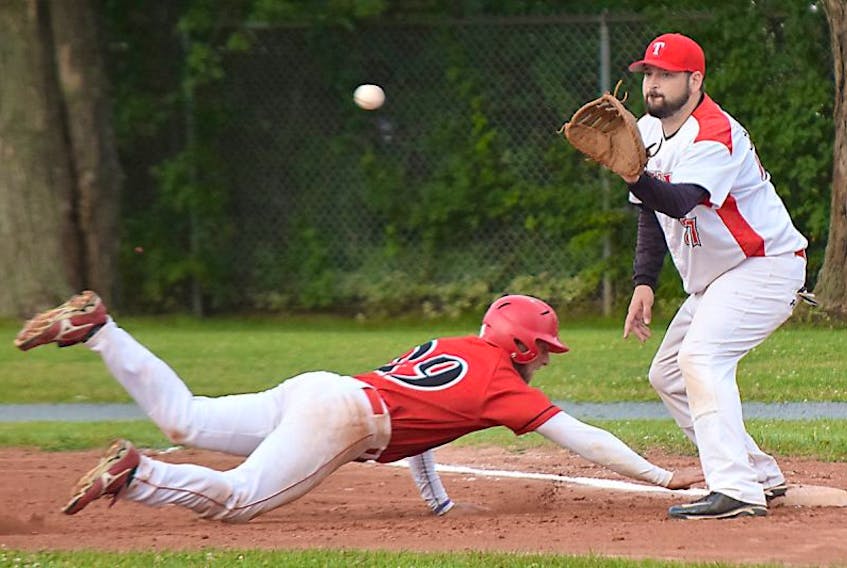 Truro Bearcats first baseman Scott Baillie catches the ball while keeping Ryan Thoms of the Kennetcook Braves close during N.S. Intermediate Baseball League action Thursday in Truro. The Bearcats won the game 8-7.