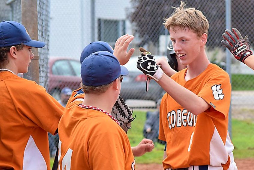 Connor Irwin exchanges high-fives and fist bumps with teammates during the Cobequid Cougars high school baseball game on Wednesday against Hants North. The Cougars rolled to a 10-0 victory.