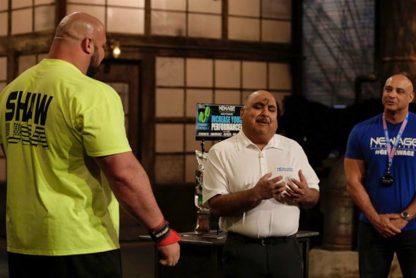 Brian Shaw, left, who has held the title of World’s Strongest Man four times, is seen with Truro dentist Dr. Anil Makkar, middle, and a representatives from the New Age Performance Mouthware company, during a recent taping of the CBC television show, Dragon’s Den.