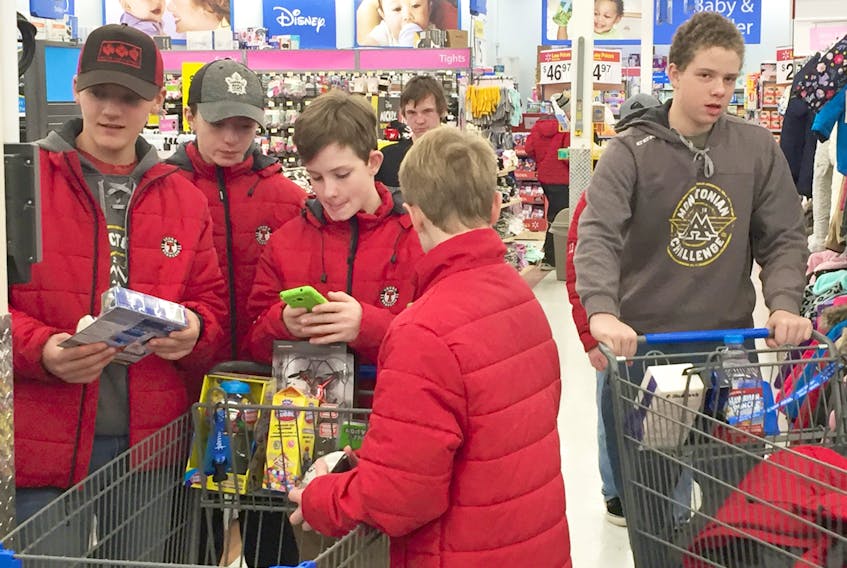 Truro Major Bantam Bearcats Andyn Furmidge (left), Nik Xidos, Brandon Forbes, Aiden Tucker (with back to camera), Jeremiah Martin and, in the background, Bryson Currie, at the Truro Wal-Mart Dec. 9, taking part in an activity to support a family in need this Christmas season. Richard MacKenzie