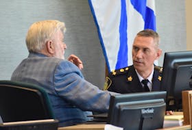 Acting police chief Robert Walsh of the Cape Breton Regional Police Service speaks with Coun. Jim MacLeod in the Cape Breton Regional Municipality council chambers at the civic centre in Sydney in this file photo. CAPE BRETON POST
