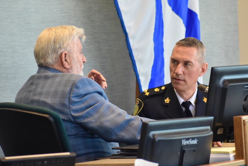 Acting police chief Robert Walsh of the Cape Breton Regional Police Service speaks with Coun. Jim MacLeod in the Cape Breton Regional Municipality council chambers at the civic centre in Sydney in this file photo. CAPE BRETON POST