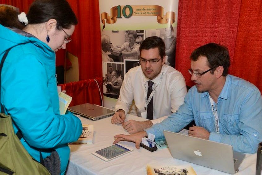 <span>Kori Abrams, left, speaks with Stephane Blanchard and Jean Phyllippe of RDEE IPE at the 11th annual Tourism Job Fair held Wednesday at the Murchinson Centre in Charlottetown. The fair gave people to opportunity to speak with potential employers.<br /></span>