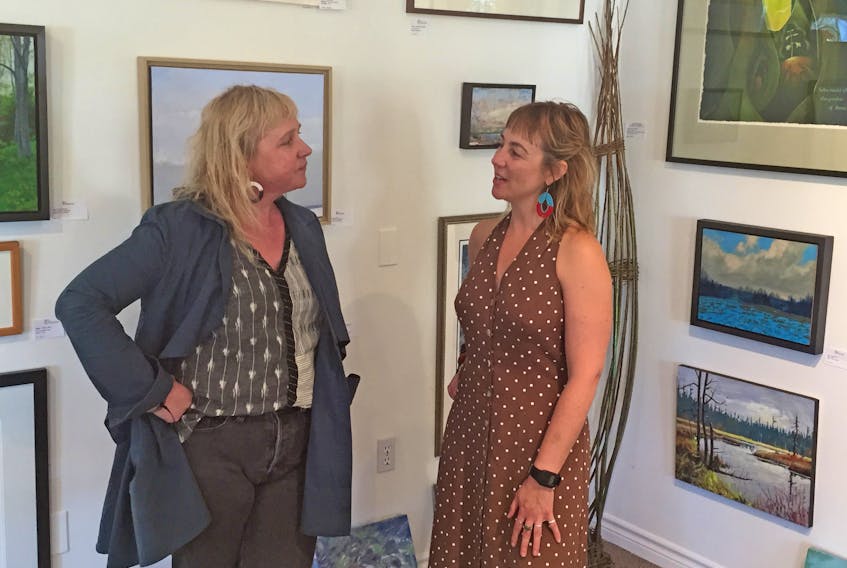 Owner Rosemary Curry (left) and Rose Murphy discuss plans for the upcoming Travel Tales – trauma and triumph on the road – a storytelling open mic that will take place Tuesday, Sept. 24, beginning at 7 p.m., at the Red Sky Gallery on Main Street in Antigonish. Corey LeBlanc