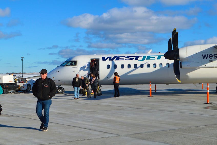 Passengers disembark from a WestJet aircraft at the JA Douglas McCurdy Sydney Airport, Monday. Airport officials say the upcoming flight schedules are cost-effective with quick connections with WestJet flights to Europe. Sharon Montgomery-Dupe/Cape Breton Post