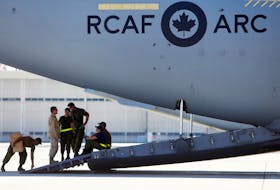 Technicians on the ramp of a CC-177 Globemaster III plane await the arrival of their cargo   Tuesday, July 3, 2018 at Canadian Forces Base Trenton, Ont. Nearly 300 Canadians evacuated from Wuhan will be quarantined for 14 days at the base camp.