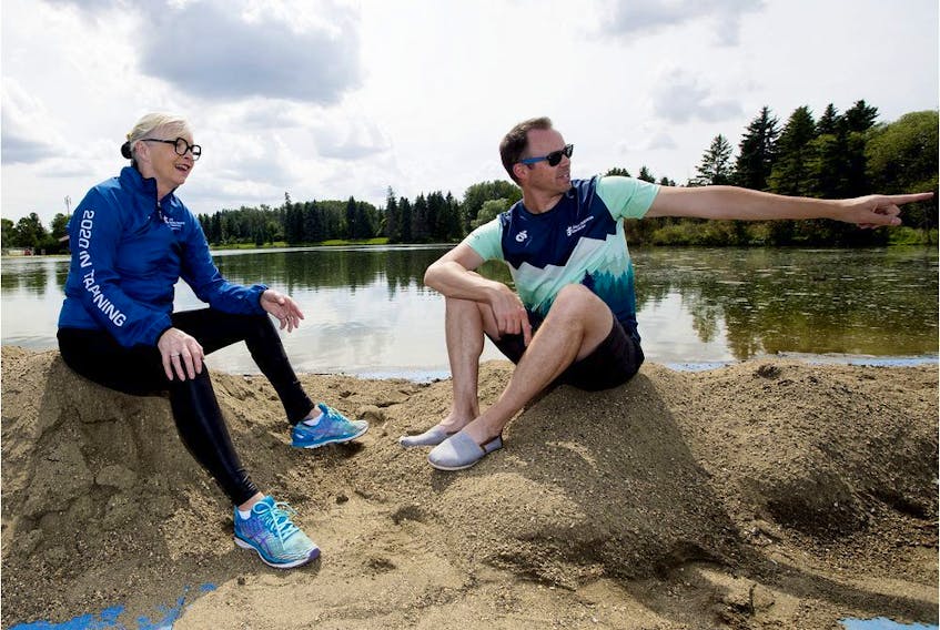 World Triathlon Edmonton president Sheila O'Kelly and World Triathlon Edmonton general manager Stephen Bourdeau are seen at the swimming starting line, as they prepare for next week's event, in Edmonton's Hawrelak Park, Sunday, July 14, 2019.  