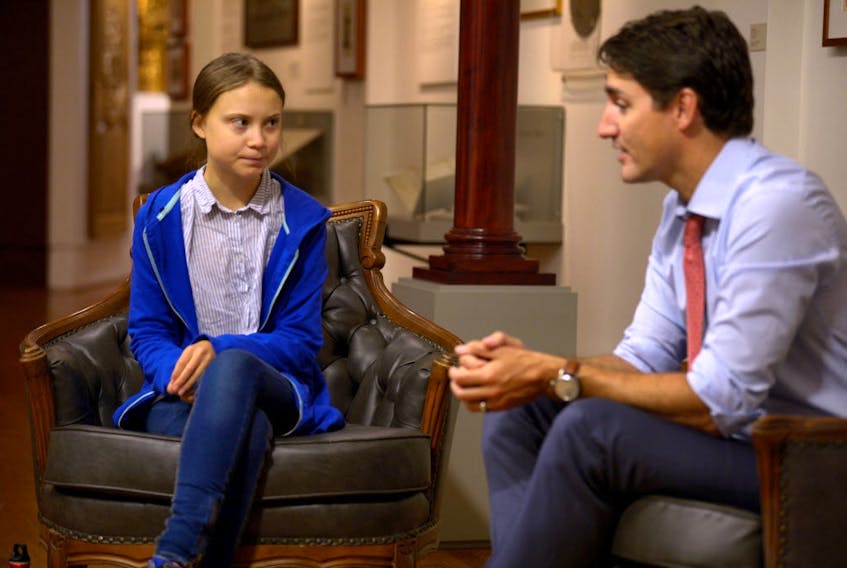 Prime Minister Justin Trudeau greets Swedish climate change teen activist Greta Thunberg before a climate strike march in Montreal on  Sept. 27, 2019.  