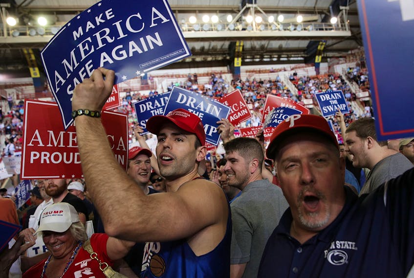 Supporters hold up signs prior to a "Make America Great Again Rally" at the Pennsylvania Farm Show Complex &amp; Expo Center April 29, 2017 in Harrisburg, Pennsylvania.