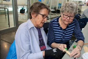 Judy Decker, left, got some help from Cathy Olsen when she tried woodcarving for the first time. Decker, who has Parkinson’s disease, hopes carving will help her with dexterity. LYNN CURWIN/TRURO NEWS