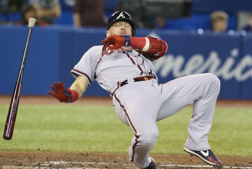 Atlanta Braves third baseman Josh Donaldson is knocked down at the plate in the seventh inning at the Rogers Centre on Tuesday night. Veronica Henri/Toronto Sun/Postmedia Network
