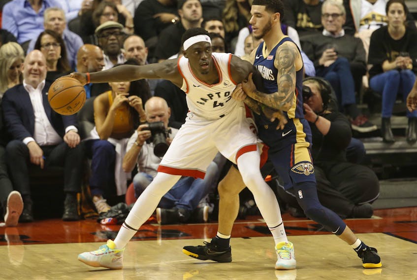 Toronto Raptors Pascal Siakam, left, looks to get past New Orleans Pelicans Lonzo Ball during the second quarter in Toronto, Oct. 22, 2019. (Jack Boland/Toronto Sun/Postmedia Network)