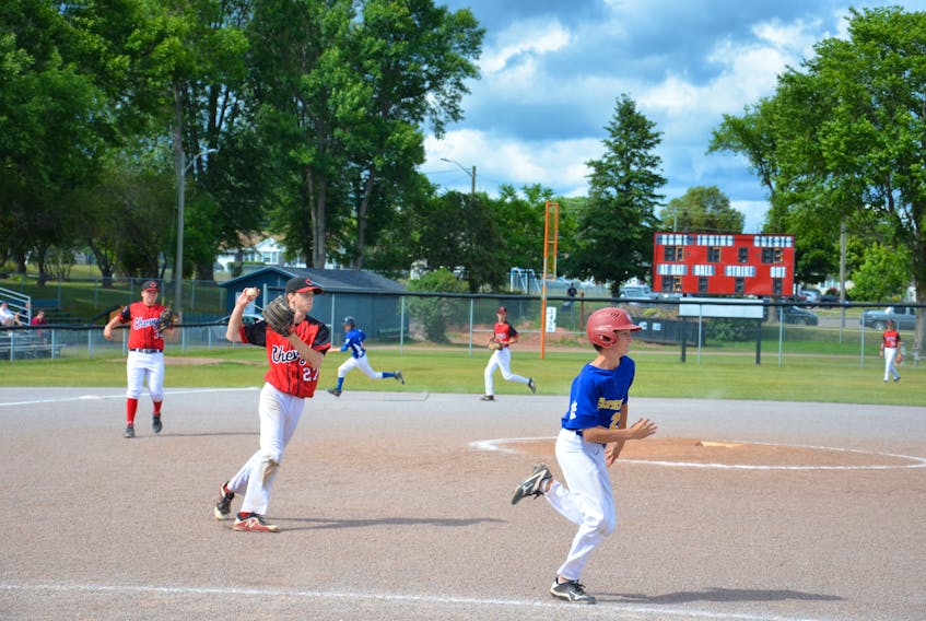 Summerside Chevys pitcher Owen Lynch fields the ball while batter Dillon MacLean runs to first base during the championship game of the Summerside 15-under AAA baseball tournament at Queen Elizabeth Park’s Very Important Volunteer Field on Sunday afternoon. Eastern won the contest 6-3.