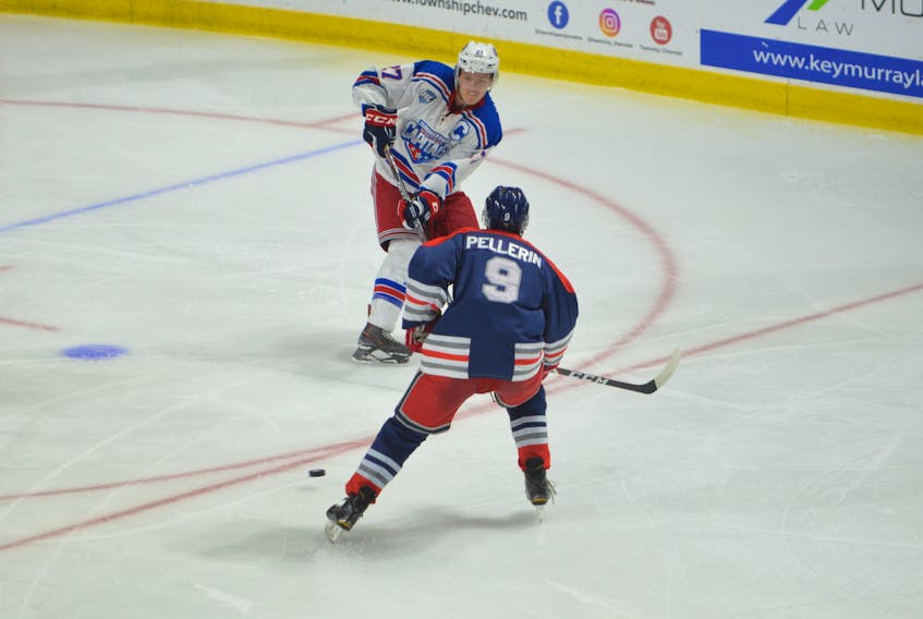 Summerside Western Capitals forward Brodie MacArthur makes a pass while being defended by the South Shore Lumberjacks’ Patrick Pellerin during a Maritime Junior Hockey League regular-season game at Eastlink Arena in Summerside.