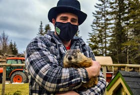 Park attendant Jarrett Lewis holds Two Rivers Tunnel following the groundhog's early spring announcement on Groundhog Day at Two Rivers Wildlife Park in Huntington. JESSICA SMITH • CAPE BRETON POST