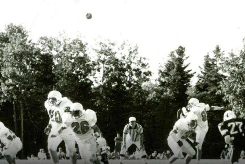 UCCB Capers player Mark Pearce, right, delivers a punt during an Atlantic Universities Athletic Association game against Mount Allison during the 1990 football season at the Canadian Coast Guard College in Westmount. Today, after a short professional playing career, Pearce owns his own blacksmith business in Calgary, Alta. CONTRIBUTED
