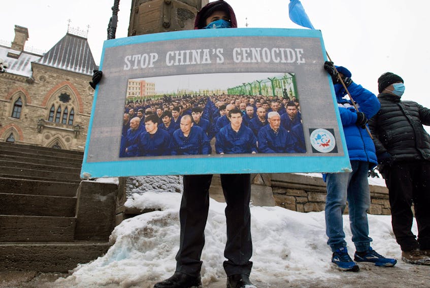  Protesters gather outside the parliament buildings in Ottawa, Monday, February 22, 2021 before a vote to recognize China’s actions against ethnic Muslim Uighurs as genocide passed unanimously.