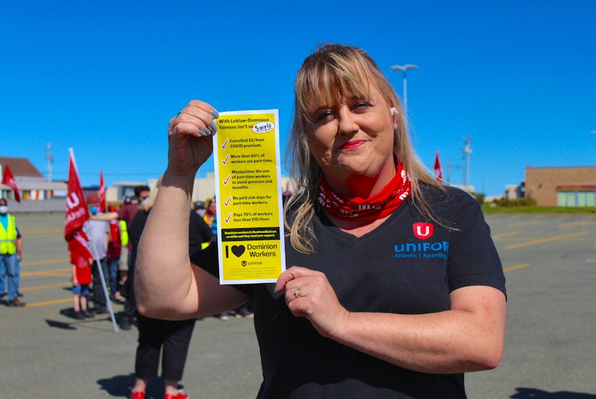 Unifor Atlantic regional director Linda MacNeil holds a leaflet that Unifor members from across the country were handing out on Labour Day in support of striking Dominion workers in Newfoundland and Labrador. — Andrew Waterman/The Telegram