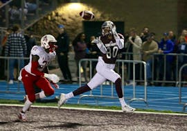 Saint Mary’s Huskies receiver Lerone Robinson (80) hauls in a touchdown pass in front of Acadia Axemen defender Garvin Cius during AUS football league action on Friday night at Huskies Stadium.