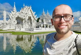 Ricky Jamer in front of the Wat Rong Khun Buddhist temple in Chiang Rai Province, Thailand.
