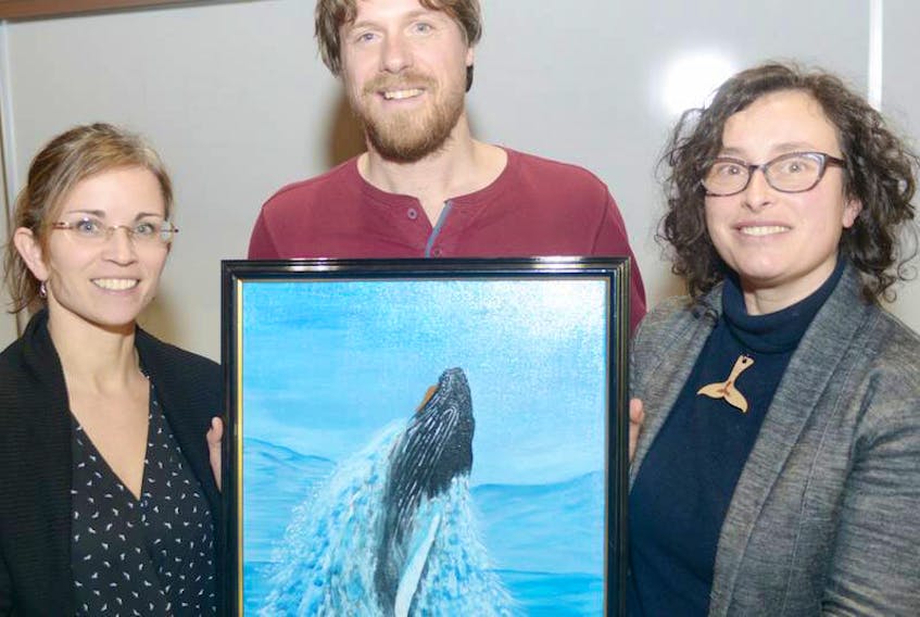 Marine Animal Response Society Tonya Wimmer, from left, Save Our Seas and Shores P.E.I. chair Colin Jeffrey and Sierra Club Canada Foundation national program director Gretchen Fitzgerald, display a painting of a whale following a fundraiser at UPEI on Jan. 21, 2018 in support of increased protection of the Gulf of St. Lawrence.

(The Guardian / Mitch MacDonald)