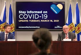 Nova Scotia Premier Iain Rankin listens as Dr. Robert Strang, chief medical officer of health, speaks at a COVID-19 briefing on Tuesday, March 16, 2021.