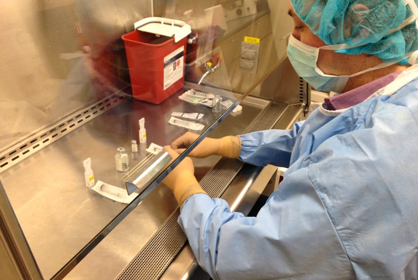 Scientist preparing vaccines for injection at the Canadian Center for Vaccinology in 2015.