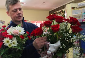 David MacKillop, owner of MacKillop’s Flowers, arranges roses at his shop in Sydney River. MacKillop and other florists are gearing up for some last minute Valentine’s Day business. GREG MCNEIL/CAPE BRETON POST