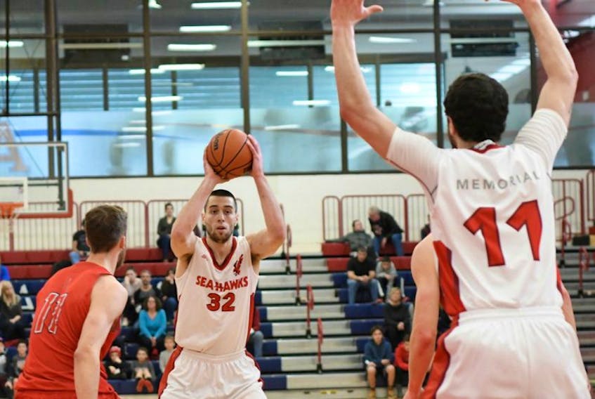 Vasilije Curcic (32) of the Memorial Sea-Hawks looks to make a pass to teammate Jacob Hynes (11) during Atlantic University Sport (AUS) men’s basketball action at Acadia University in Wolfville, N.S., over the weekend. The Sea-Hawks finished their 2016-17 AUS regular-season by splitting two games with the Axemen. Fourth-place Memorial will take on fifth-place Acadia in a playoff quarter-final matchup next weekend in Halifax. Saturday’s game against Acadia was the final regular-season contest for Curcic, who finished second in AUS scoring this season and as Memorial’s third-leading scorer of all time.
