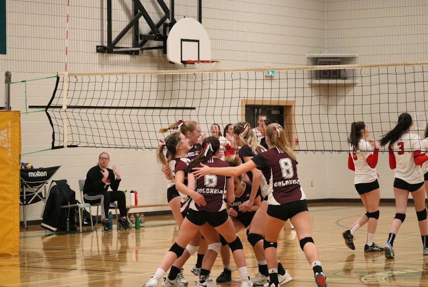 Players from the Colonel Gray Colonels cheer in delight after a successful match point to win  the Senior AAA Girls Volleyball league gold medal on Wednesday.