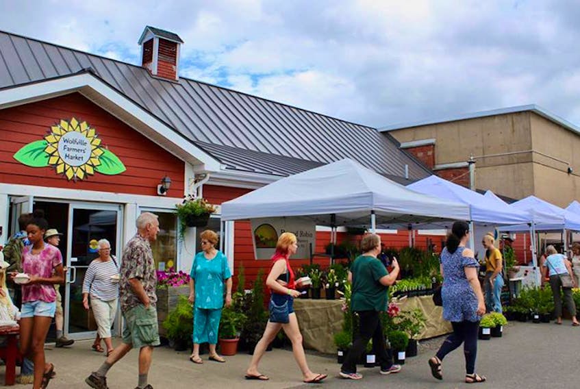 Members of the public shop at the Wolfville Farmers’ Market on a Saturday market day.