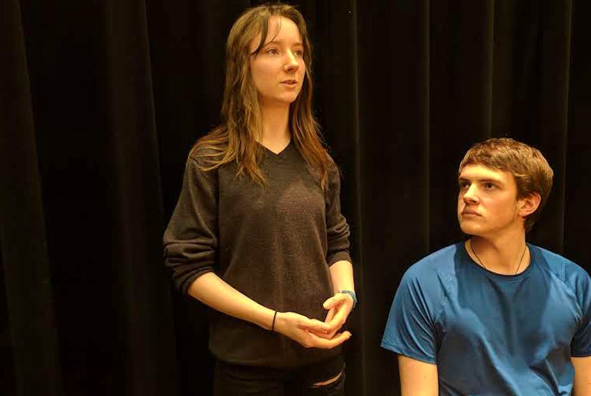 Grade 11 student Maisie Gilbert (playing Madame Winifred Robarts) questions Grade 12 student Liam Jackson (playing Leonard Vole) as they prepare for their upcoming roles in Witness for the Prosecution. Avon View High School will perform the Agatha Christie classic May 9-11.