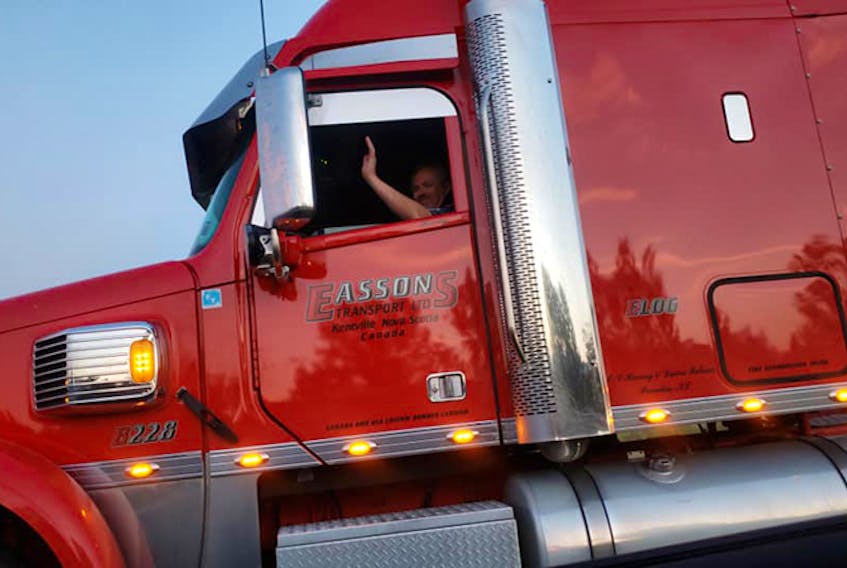 Clarissa Flint took this photo of Harvey Palmer- a long-haul trucker who works for Kentville-based company Eassons, as he waved and honked his horn to distract her young son while they were stuck in a traffic jam in Ontario. - FACEBOOK/CLARISSA FLINT