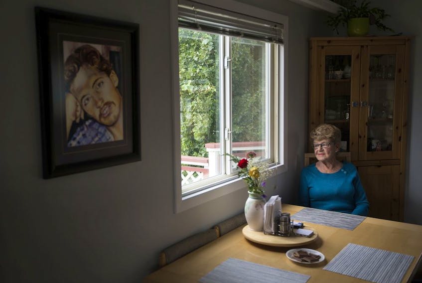 Jane Orydzuk, Victims of Homicide Support Society president and founder, sits at her kitchen table while speaking to a reporter, in Edmonton Friday Sept. 6, 2019. A portrait of her son Tim Orydzuk is visible on the wall nearby. Tim Orydzuk was murdered Oct. 1, 1994. Photo by David Bloom
