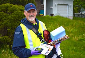 Postal worker John Donovan stands for a picture during his route on Amberwood Crescent in Westmount on Friday. Canada Post says postal workers across the country have seen an increase in parcel deliveries during the months of April and May, which were peak times for the COVID-19 pandemic. JEREMY FRASER/CAPE BRETON POST.