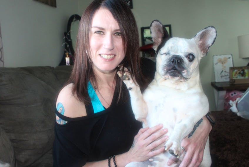 Franky looks at her owner Richelle McCormick with her paw resting McCormick's chin — one of her favourite ways to sit with her owner. NICOLE SULLIVAN/CAPE BRETON POST 