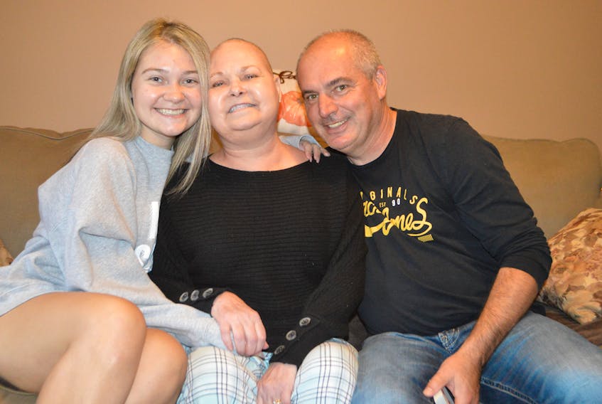 Haley Toomey, left, 23, with her parents Cayla Toomey and Tim Toomey at their home in Glace Bay, sharing incredible news that a tumour in Cayla’s brain is shrinking. The family say they will be taking part in the Cape Breton Regional Hospital Foundation RadioDay fundraiser being held at Centre 200 in Sydney on Thursday. Sharon Montgomery-Dupe/Cape Breton Post