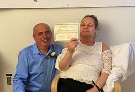 Tim Toomey, 54, and Cayla (Gouthro) Toomey, 51, of Glace Bay, proudly show their wedding certificate after getting married May 27 at the Cape Breton Regional Hospital in Sydney. The couple were together on and off for 30 years but ended back together permanently 10 years ago. CONTRIBUTED
