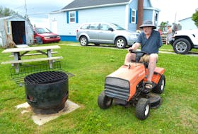 Tommy DeGiobbi mows the lawn at his home in River Ryan. DeGiobbi said he has lost an arm, most of a lung and a kidney and never would have known he had cancer if not for slipping and falling while working in a coal mine 20 years ago. Sharon Montgomery-Dupe/Cape Breton Post
