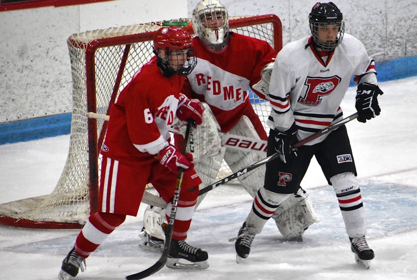 Jarrett Hicks of the Glace Bay Panthers, right, stands near Riverview Redmen goaltender Michael MacMullen, middle, and Owen Burke during Cape Breton High School Hockey League championship action at the Canada Games Complex on Feb. 27. The Redmen won the game 6-1 and took the league final 2-0. Riverview and Glace Bay will both play in the Nova Scotia School Athletic Federation Division 1 provincial championship this weekend in Westville. JEREMY FRASER/CAPE BRETON POST