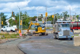 Work crews were busy installing intersection lights and putting the finishing touches on a sidewalk and curbing at Sydney’s so-called “Road to Nowhere” on Wednesday. It is expected that the thoroughfare will be ready for through traffic by the end of the construction season. DAVID JALA/CAPE BRETON POST