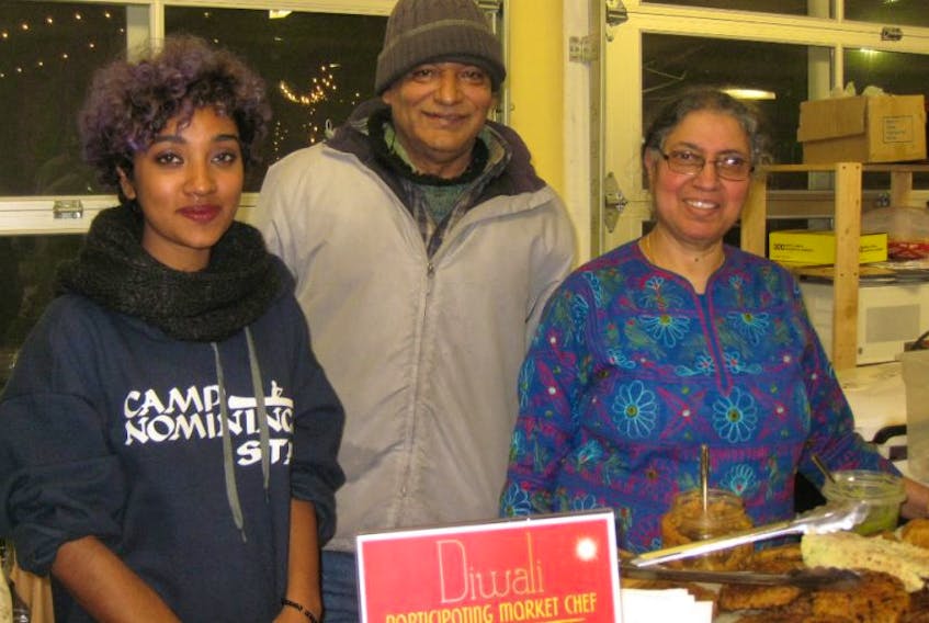 Vijay Mahajan, right, her brother Suresh and Acadia University international student Irfana Hameed were happy to take part in the Diwali event Nov. 9 at the Wolfville Farmers Market.